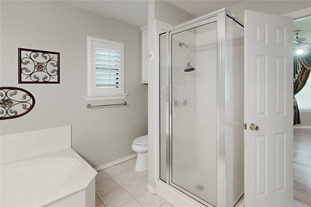 5901 Sheffield Terrace Lane Bryan, TX 77802 - Photo 16 of 31 Full bath with double vanities and soaker tub, separate shower, and light tile flooring