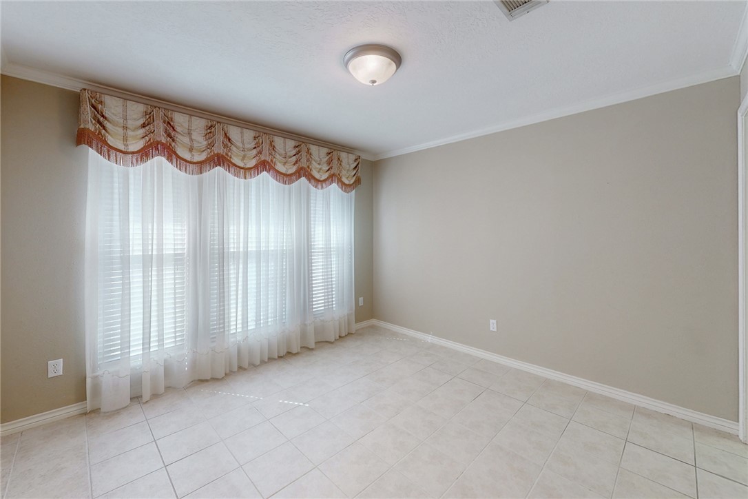 5901 Sheffield Terrace Lane Bryan, TX 77802 - Photo 6 of 31 Dining Room featuring large windows, crown molding, and light tile flooring