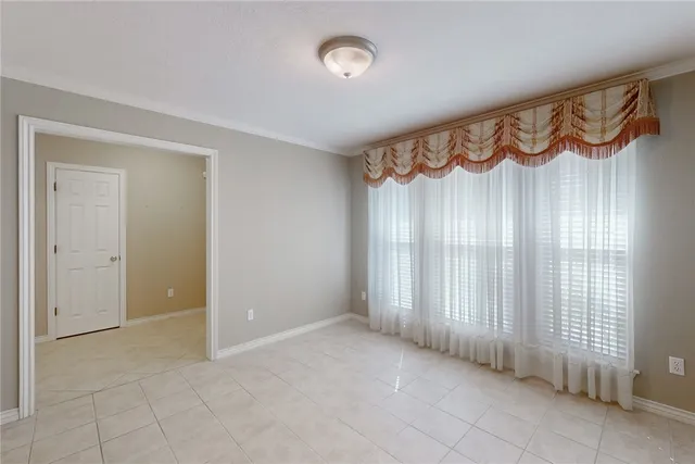 an empty room with fireplace and fan