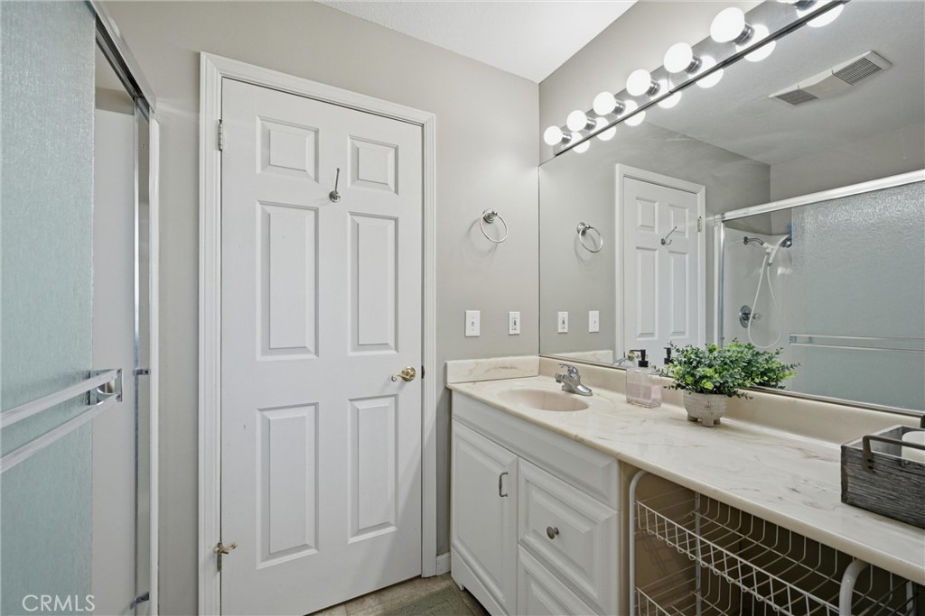 17432 Greenridge Road Hidden Valley Lake, CA 95467 - Photo 57 of 72 a spacious bathroom with a double vanity sink a large mirror and shower