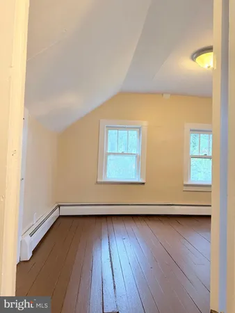 a view of wooden floor and windows in a room