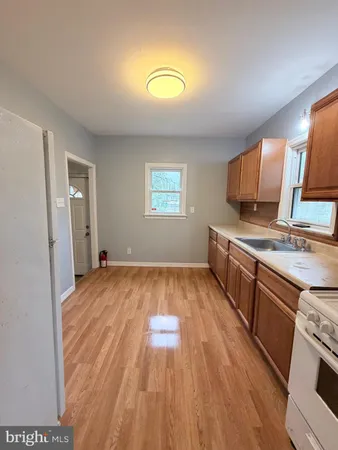 a kitchen with a wooden floor and a sink