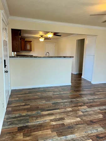a view of a room with wooden floor