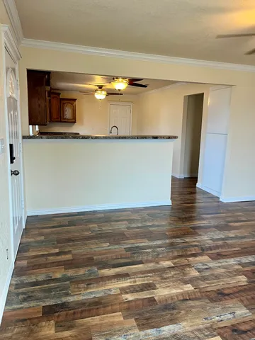 a view of a room with wooden floor