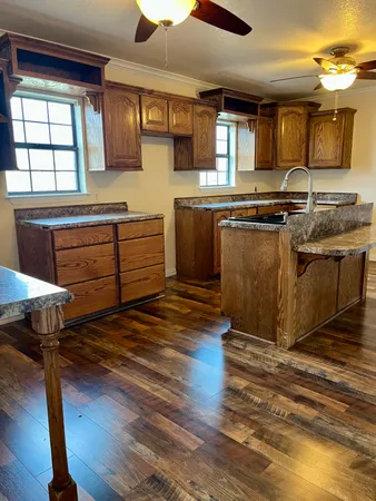 a kitchen with stainless steel appliances granite countertop a stove a sink and a microwave