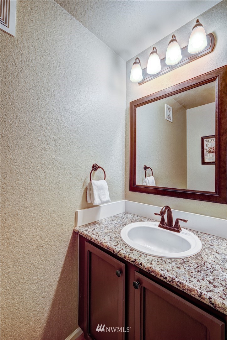 23221 13th Place West Bothell, WA 98021 - Photo 12 of 29 a bathroom with a granite countertop sink and a mirror