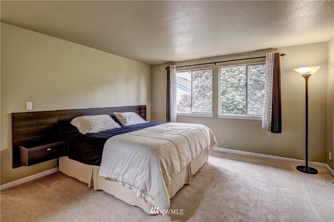 23221 13th Place West Bothell, WA 98021 - Photo 14 of 29 a bed sitting in a bedroom next to a window