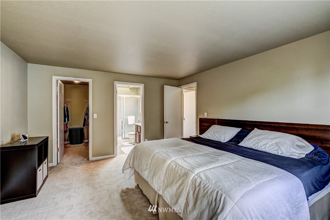 23221 13th Place West Bothell, WA 98021 - Photo 15 of 29 a bedroom with a large bed and hallway