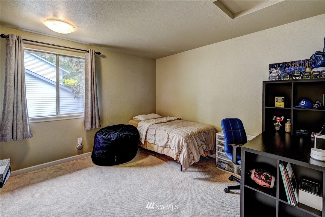 23221 13th Place West Bothell, WA 98021 - Photo 18 of 29 a bedroom with a bed and a window