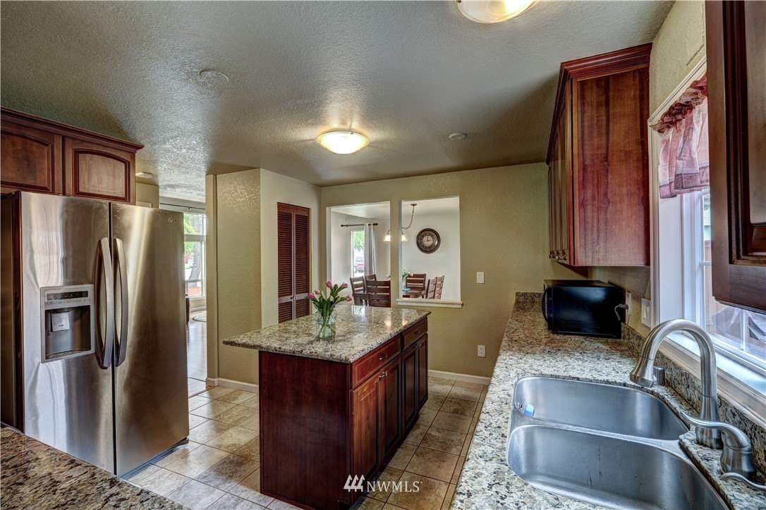 23221 13th Place West Bothell, WA 98021 - Photo 8 of 29 a kitchen with a refrigerator stove and sink