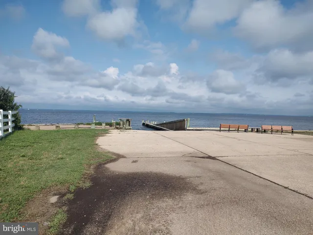a view of a dry yard with wooden fence