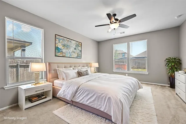 a spacious bedroom with a bed and a window