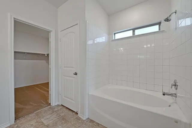 a white bath tub sitting in a bathroom