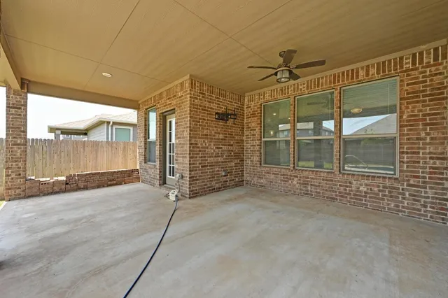 a view of a porch with wooden floor and a window