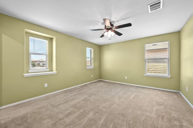 a view of a livingroom with a ceiling fan and window