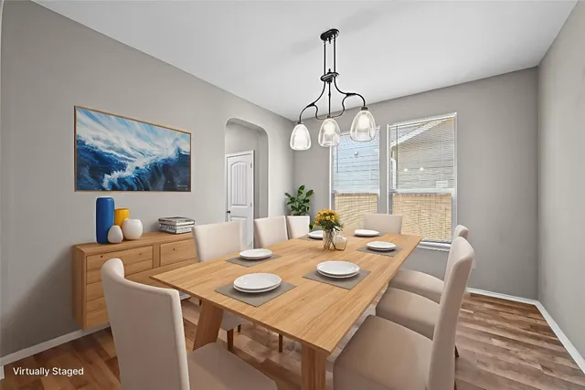 a view of a dining room with furniture wooden floor and chandelier