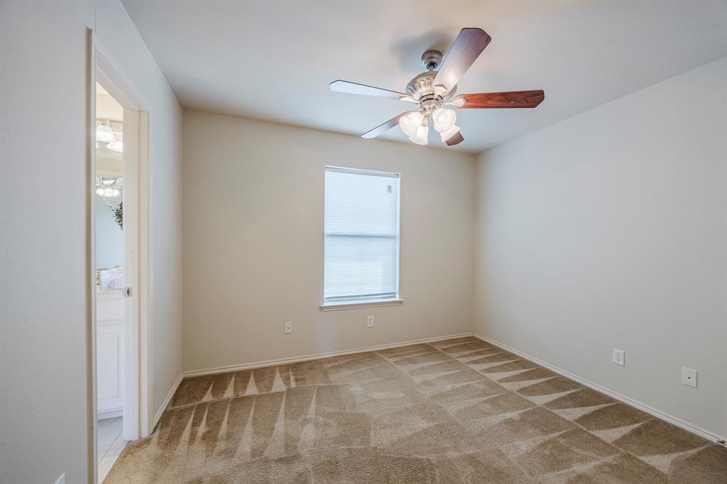 103 Janis Street, Unit B Alvarado, TX 76009 - Photo 17 of 35 an empty room with windows and fan