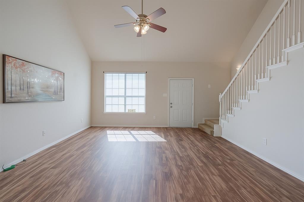 103 Janis Street, Unit B Alvarado, TX 76009 - Photo 2 of 35 a view of an empty room with wooden floor and a window
