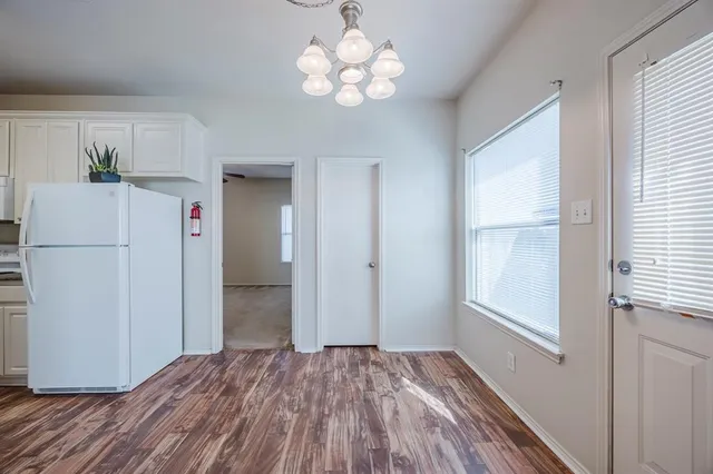 a view of a kitchen with a refrigerator cabinets and wooden floor