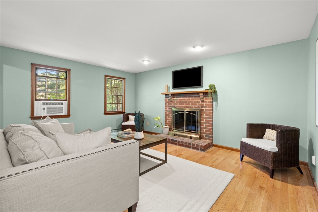 31 Kimball Road Amesbury, MA 01913 - Photo 10 of 40 a living room with furniture a fireplace and a flat screen tv