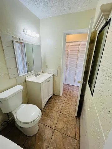 a view of a room with a wooden floor and white walls
