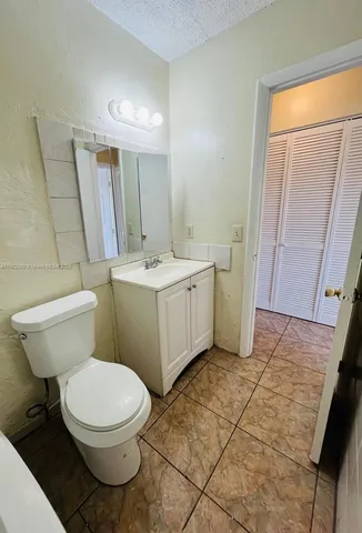 a white toilet sitting next to a bathroom sink