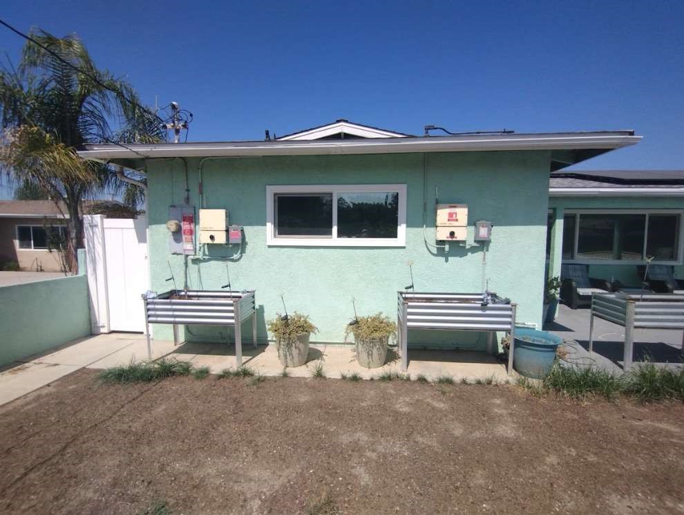 13420 3rd Street Chino, CA 91710 - Photo 2 of 3 a view of a patio with table and chairs with wooden floor and fence