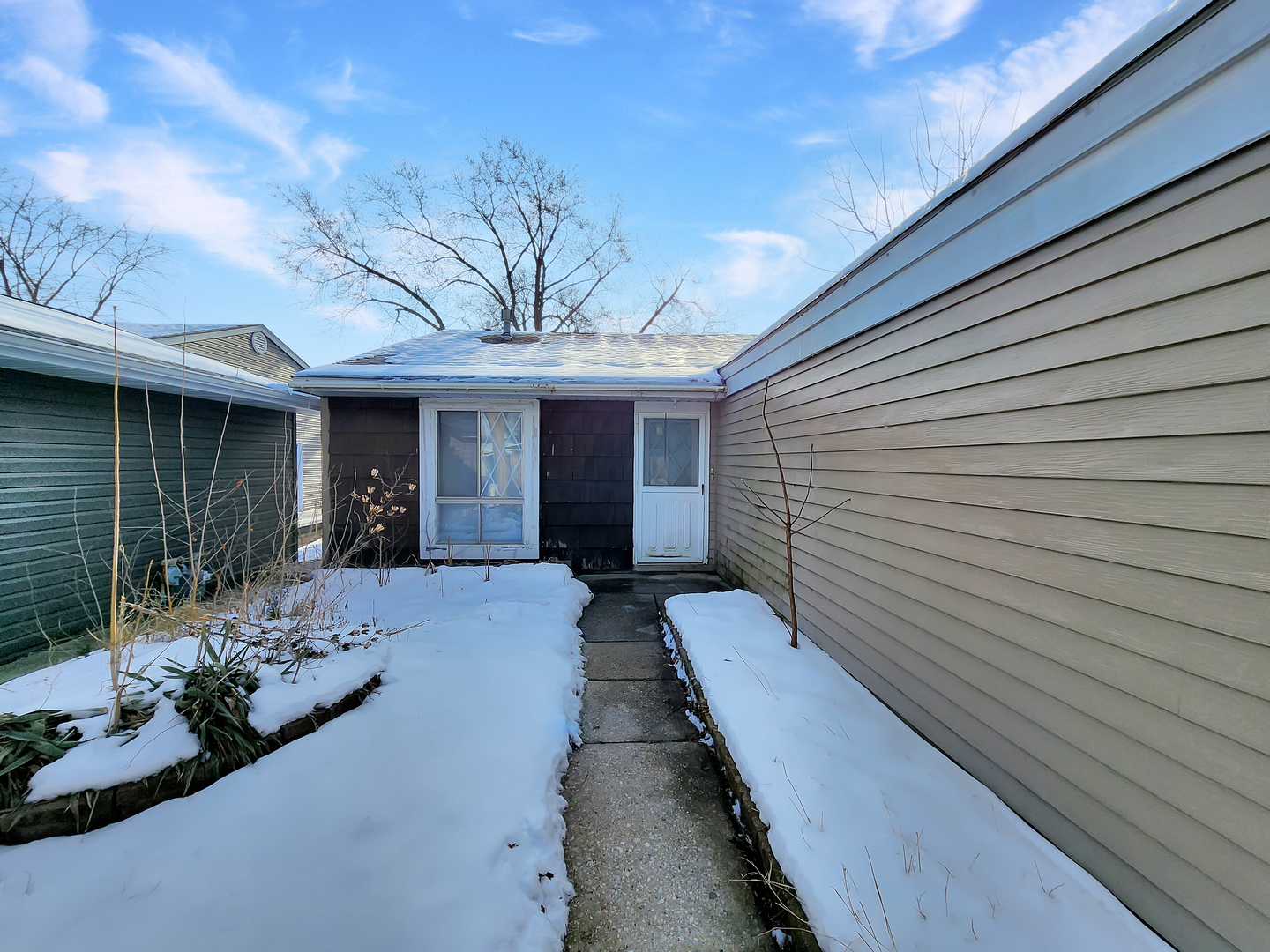 a view of a house with brick walls and a yard