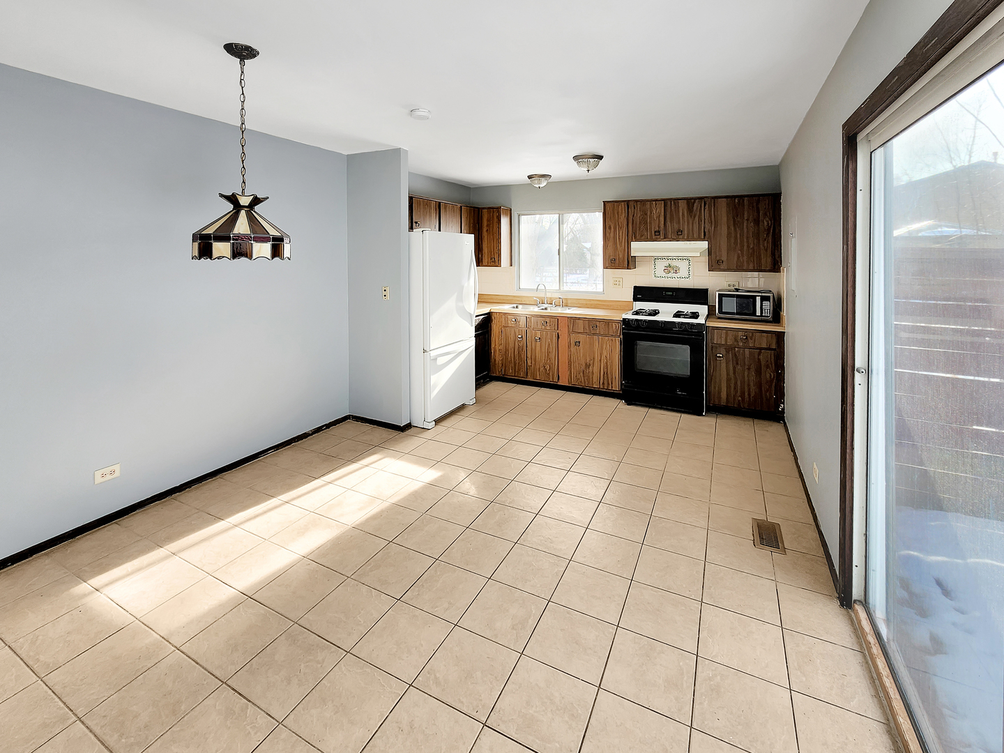 256 Waverly Drive Elgin, IL 60120 - Photo 3 of 6 a kitchen with stainless steel appliances a refrigerator sink and cabinets