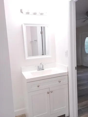 a bathroom with a granite countertop shower and a toilet