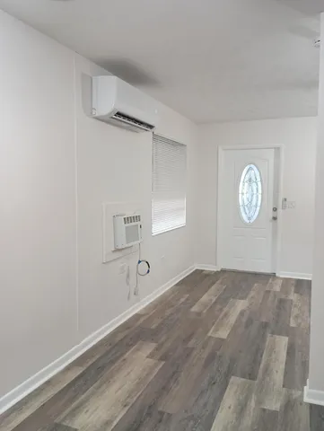 a kitchen with granite countertop wooden cabinets and a stove top oven