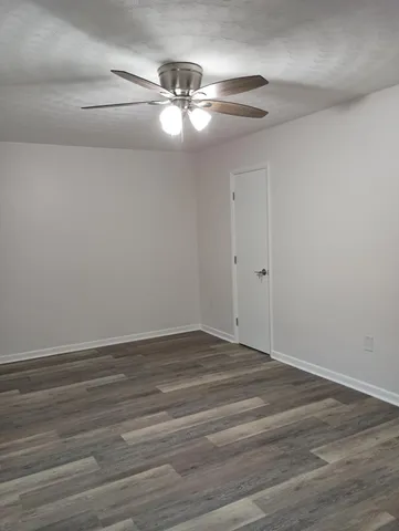 a kitchen with granite countertop wooden cabinets stainless steel appliances a sink and a window