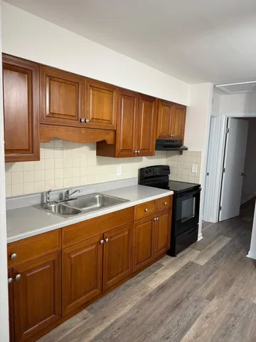 a stove top oven sitting inside of a kitchen