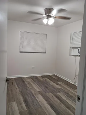 a view of a room with wooden floor