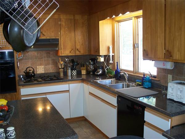 75 Woodside Road Harvard, MA 01451 - Photo 23 of 30 a kitchen with a sink a stove and cabinets