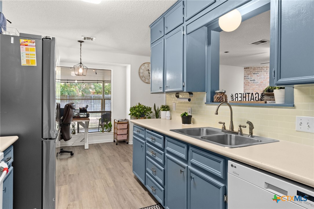 4117 Antelope Trail Temple, TX 76504 - Photo 11 of 30 a kitchen with a sink refrigerator and cabinets