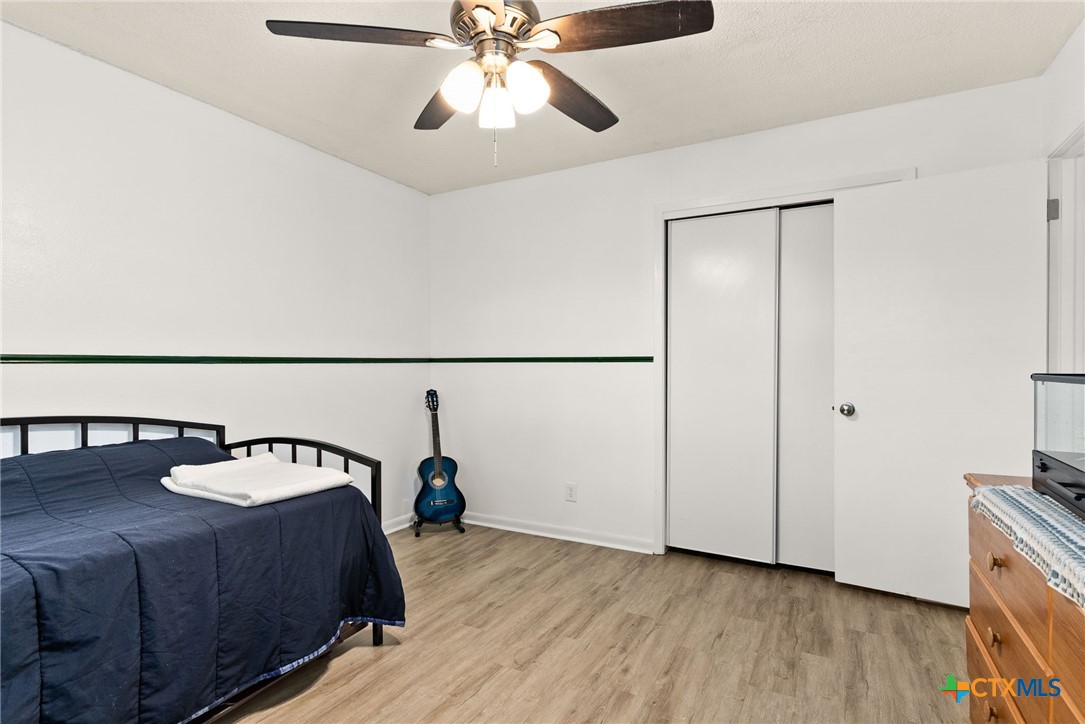 4117 Antelope Trail Temple, TX 76504 - Photo 17 of 30 a bedroom with a bed and a chandelier fan