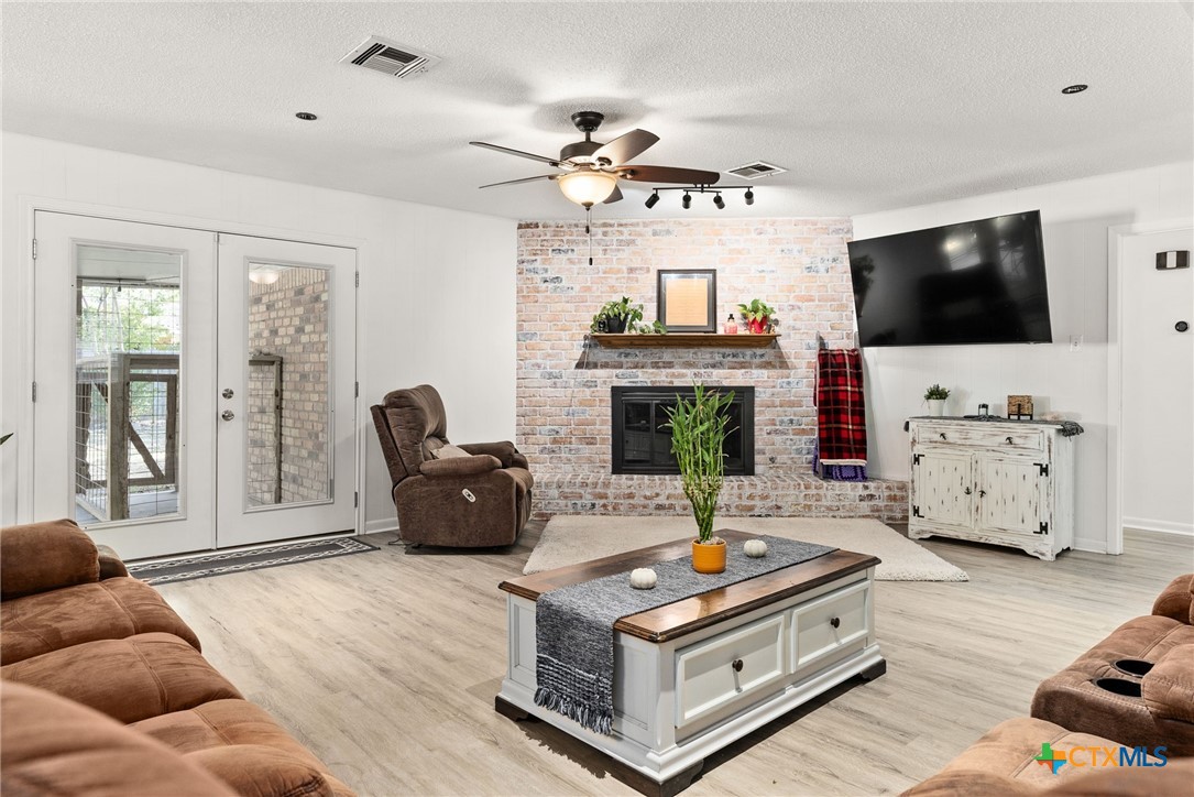 4117 Antelope Trail Temple, TX 76504 - Photo 5 of 30 a living room with furniture a flat screen tv and a fireplace