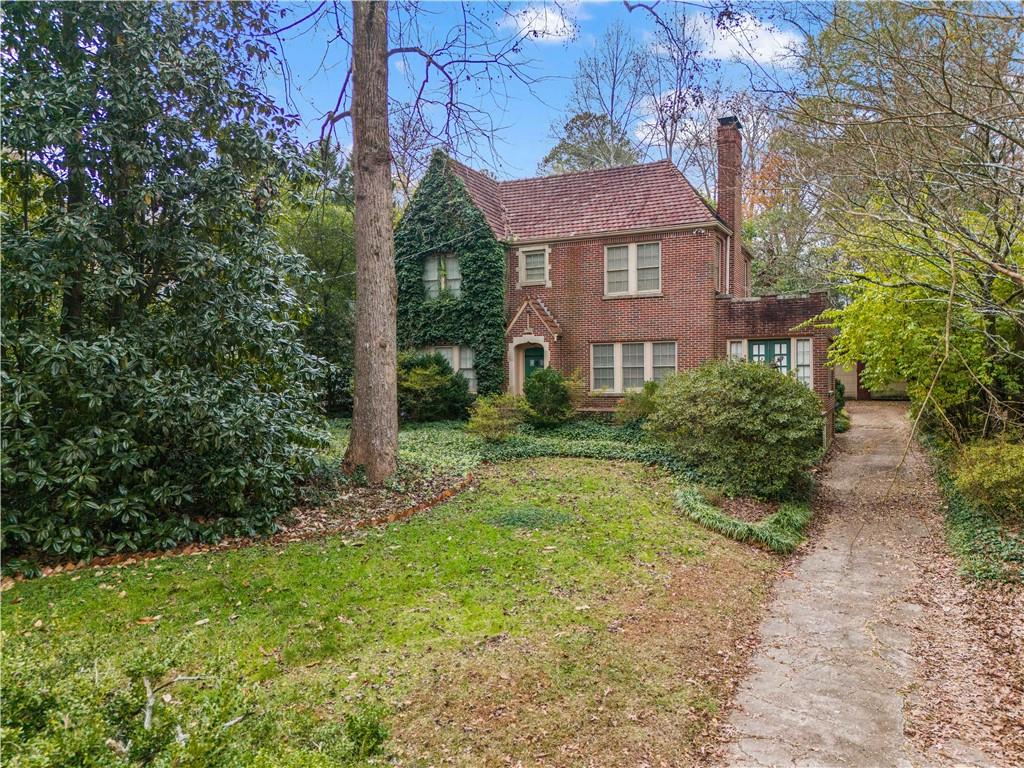 1080 East Clifton Road Northeast Atlanta, GA 30307 - Photo 1 of 29 a view of a brick house with a yard