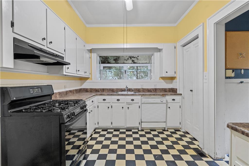 1080 East Clifton Road Northeast Atlanta, GA 30307 - Photo 12 of 29 a kitchen with a sink a stove and cabinets