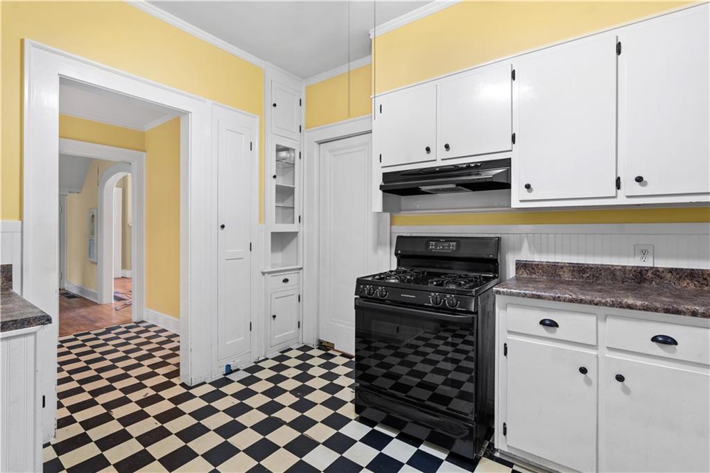 1080 East Clifton Road Northeast Atlanta, GA 30307 - Photo 13 of 29 a kitchen with granite countertop a stove and a cabinets