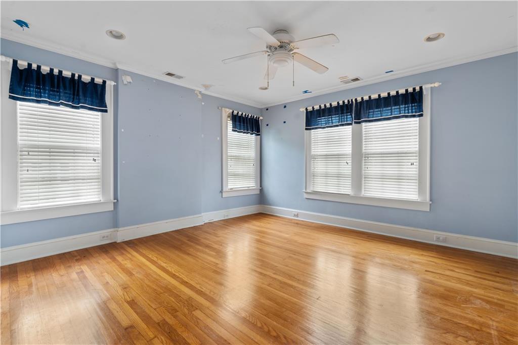 1080 East Clifton Road Northeast Atlanta, GA 30307 - Photo 16 of 29 a view of an empty room with a window and wooden floor