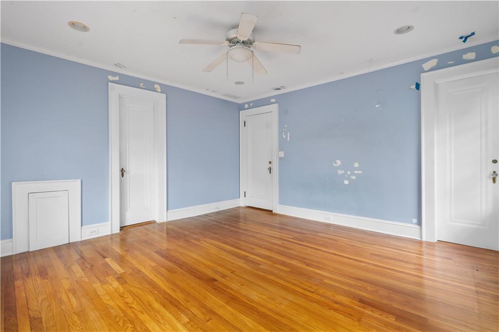 1080 East Clifton Road Northeast Atlanta, GA 30307 - Photo 17 of 29 a view of empty room with wooden floor and ceiling fan