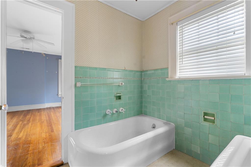 1080 East Clifton Road Northeast Atlanta, GA 30307 - Photo 19 of 29 a bathroom with a tub a window and a shower