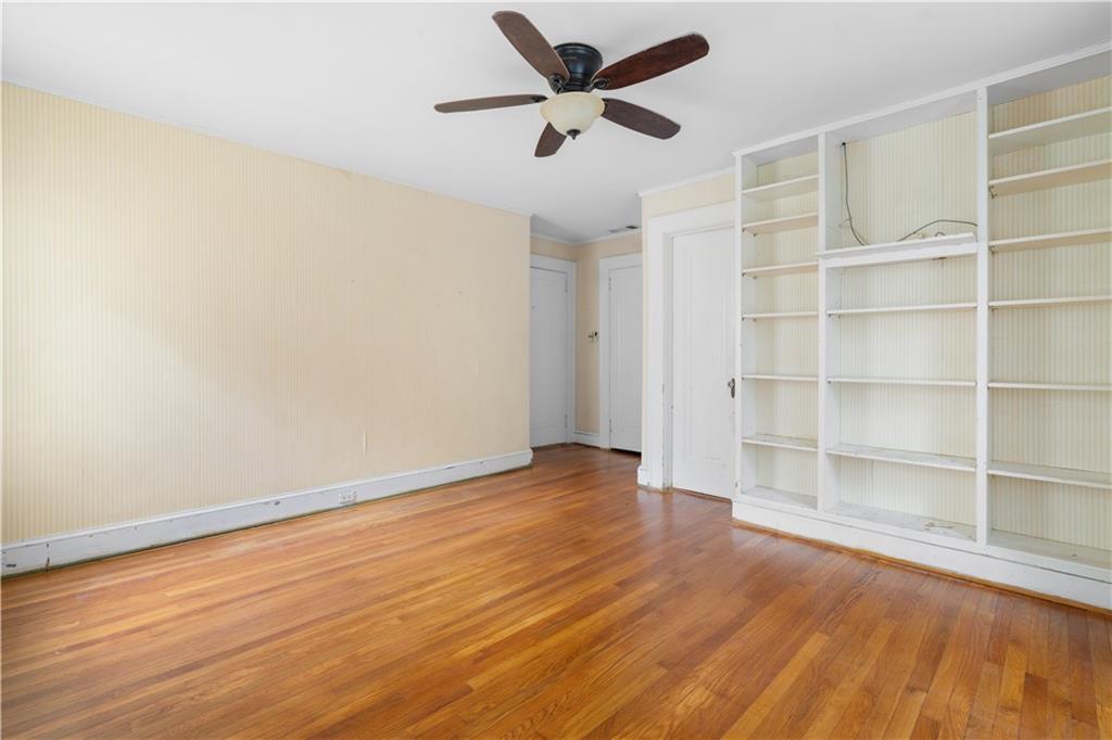 1080 East Clifton Road Northeast Atlanta, GA 30307 - Photo 21 of 29 a view of an empty room with a window and wooden floor