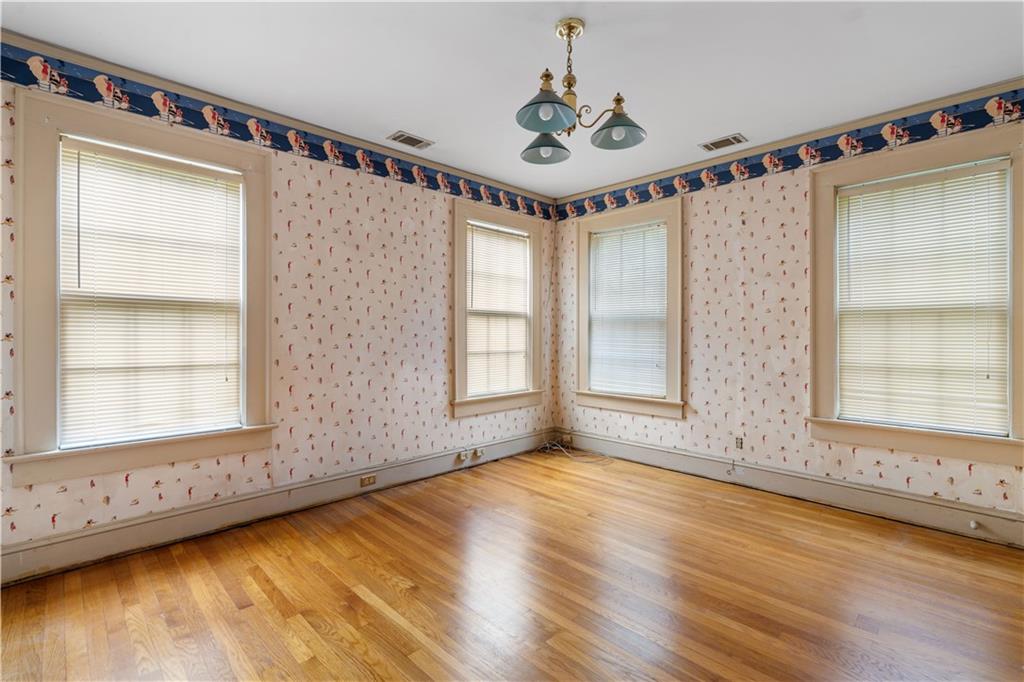 1080 East Clifton Road Northeast Atlanta, GA 30307 - Photo 22 of 29 a view of an empty room with a window and wooden floor