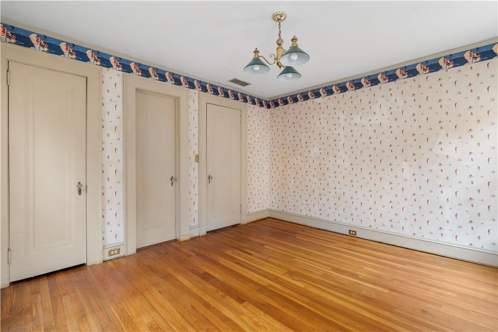 1080 East Clifton Road Northeast Atlanta, GA 30307 - Photo 23 of 29 a view of a room with a wooden floor and white walls