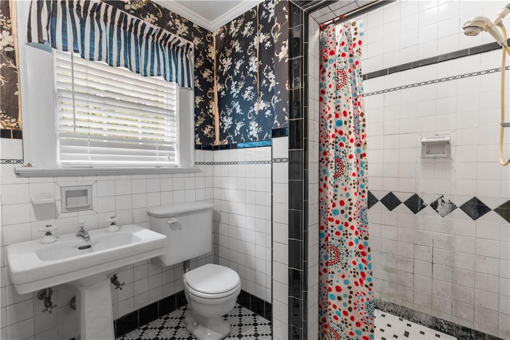 1080 East Clifton Road Northeast Atlanta, GA 30307 - Photo 24 of 29 a bathroom with a sink toilet and shower