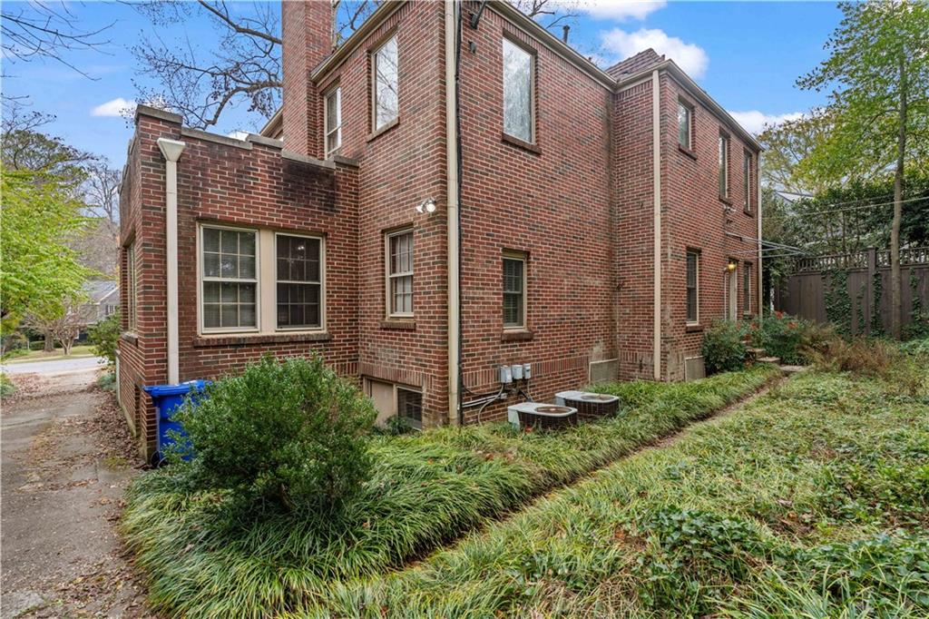 1080 East Clifton Road Northeast Atlanta, GA 30307 - Photo 29 of 29 a view of a house with brick walls and a yard with plants