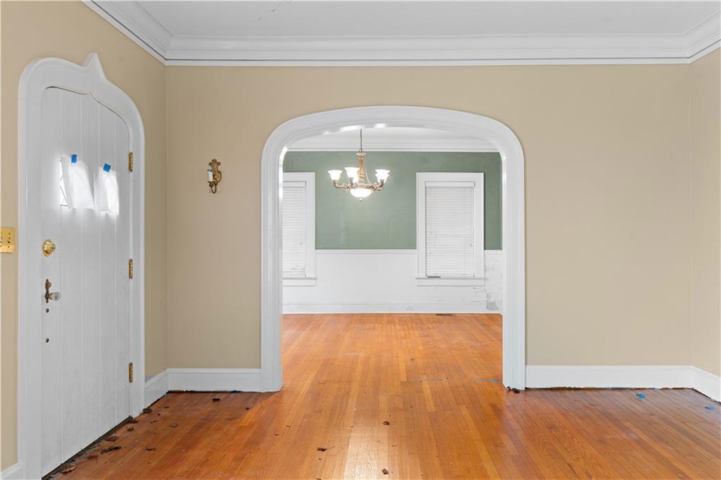 1080 East Clifton Road Northeast Atlanta, GA 30307 - Photo 9 of 29 a view of a hallway with wooden floor and a living room
